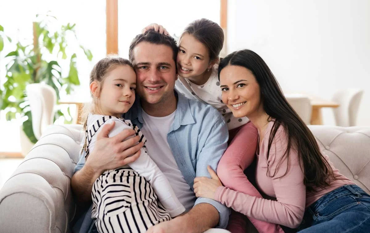 A family relaxing together at home in the UK, illustrating EU Settlement Scheme changes for status holders and family members