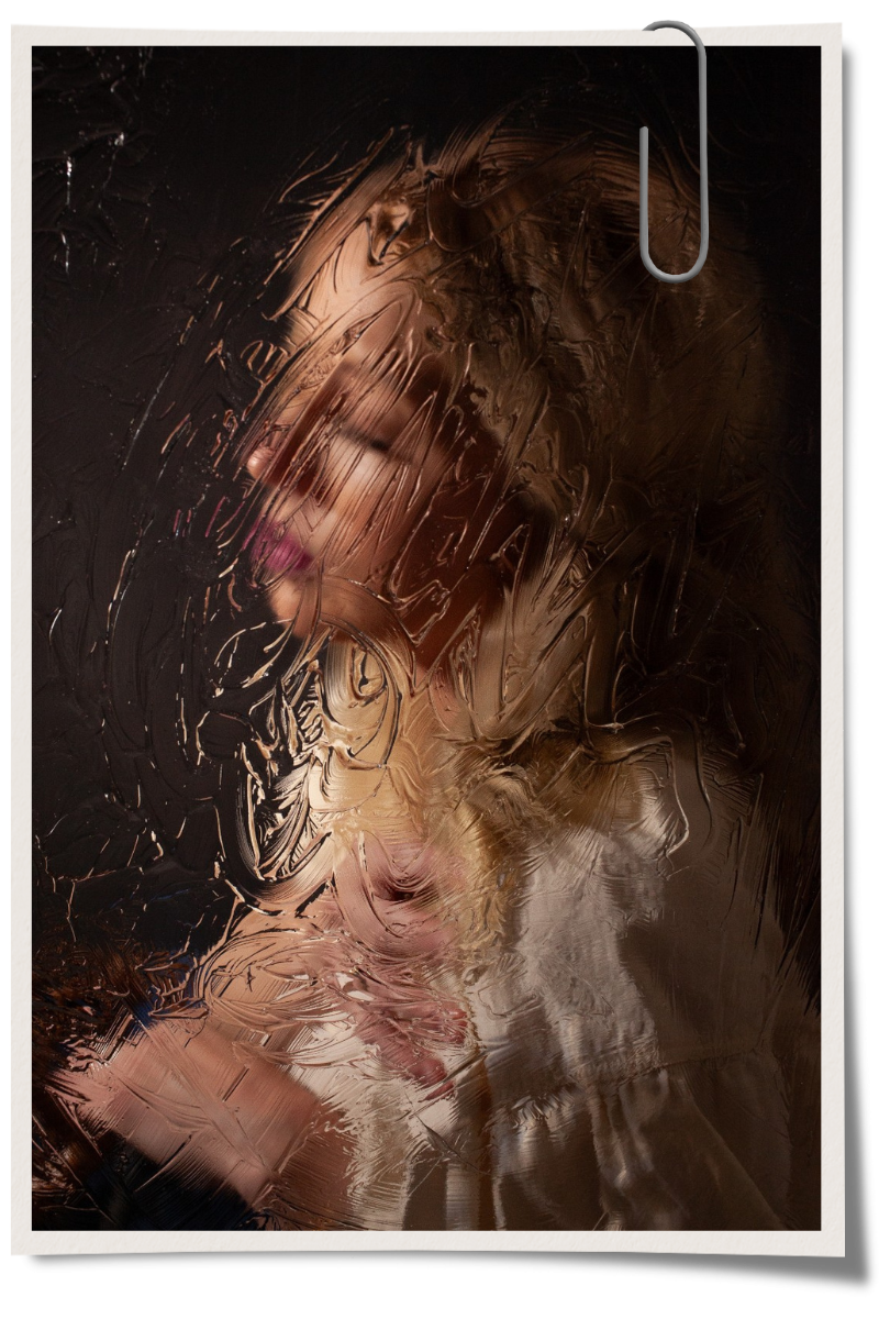 A woman with pink lipstick and makeup is seen through a foggy glass window.