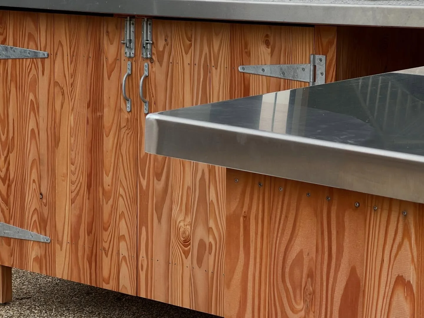 A huddle of bespoke timber outdoor storage structures in #thurlestone - potting bench, firewood/recycling shelter and lawnmower storage designed to sit perfectly into various garden nooks- Douglas Fir with fabricated stainless &amp; marine grade Alum