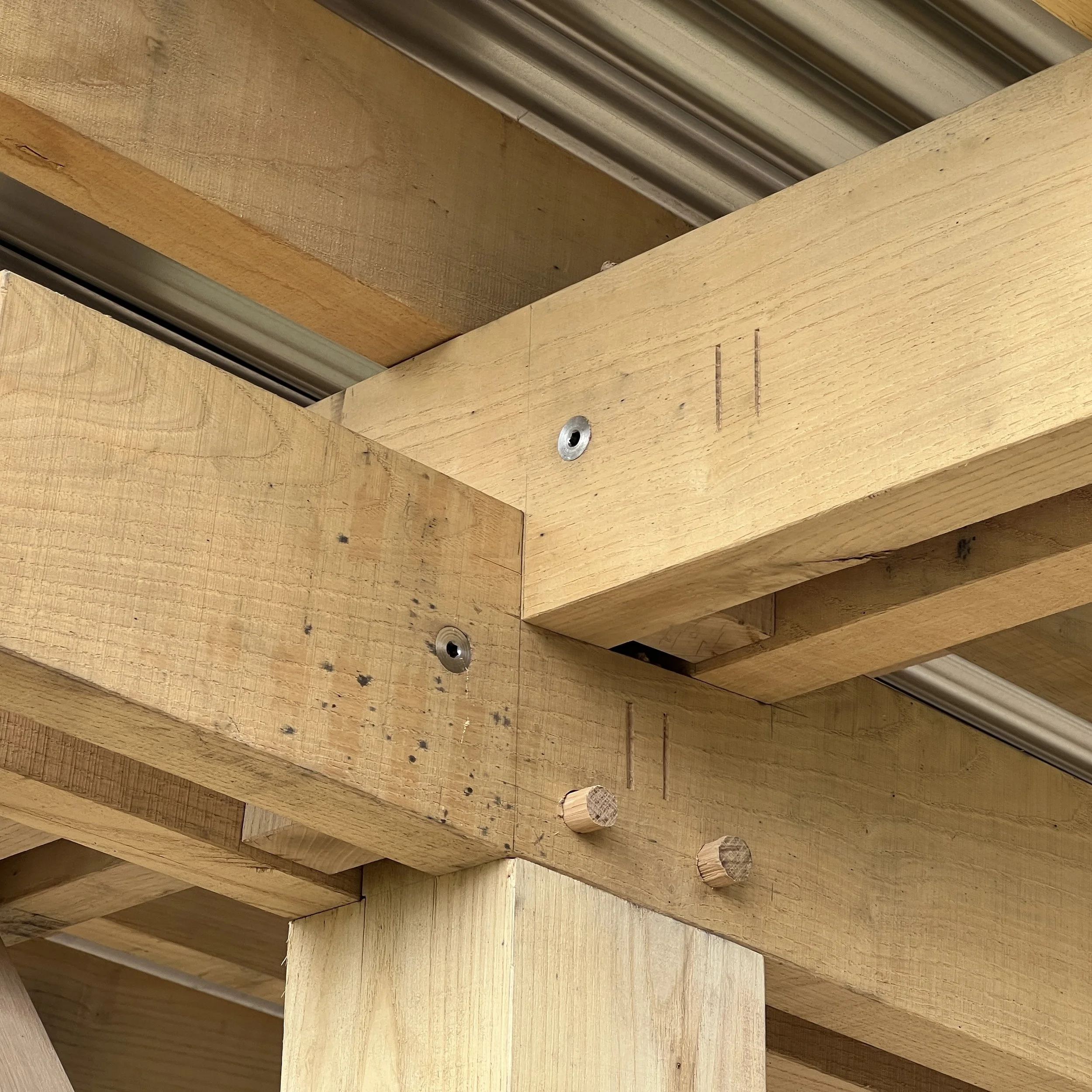 Close up of modern oak frame joint using flush stainless architectural fixings
