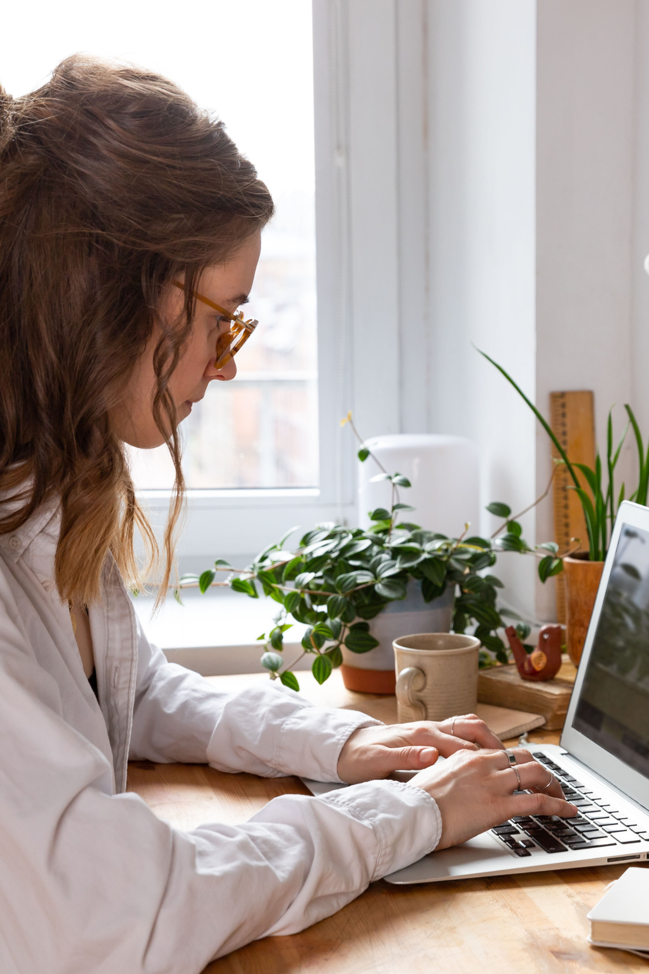 Social media marketer typing on laptop