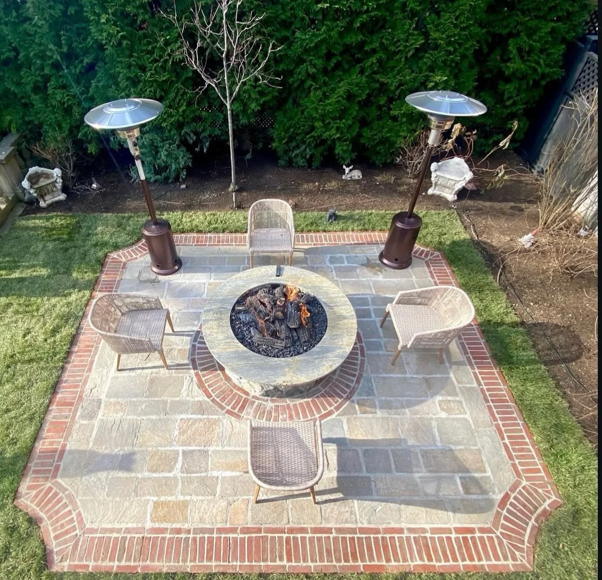 Ample yard space at this Brookline home left plenty of room for the entertaining zone the clients wanted. Repurposed stone creates a new outdoor seating area on the east terrace of the property, complete with a remote-controlled gas fire and outdoor 