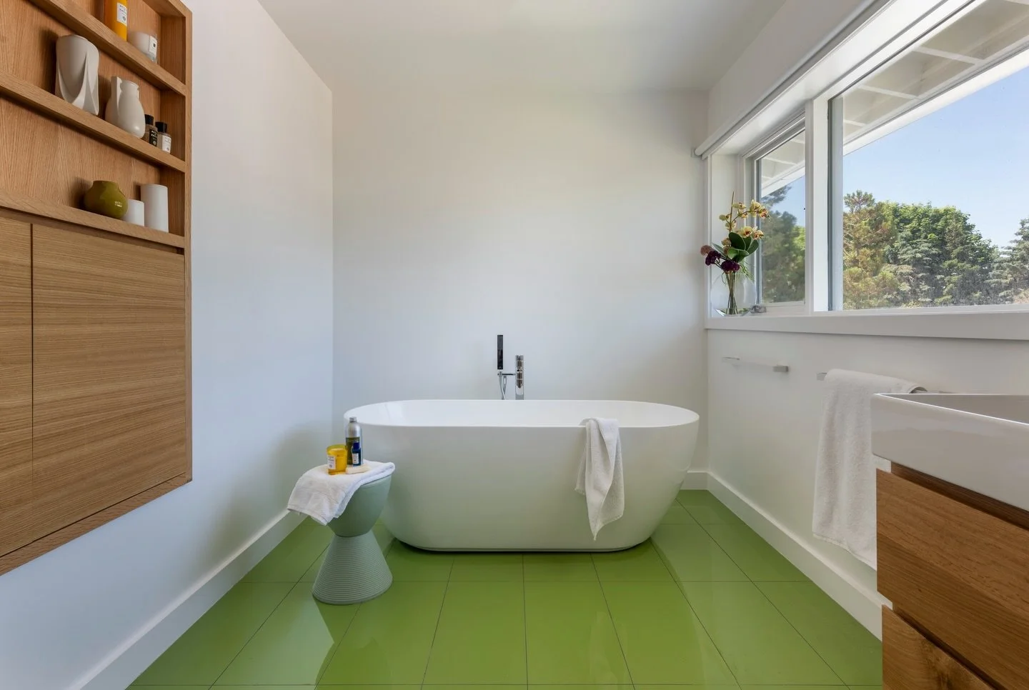 Clean lines drive this bathroom. Built in collaboration with @flavinarchitects this Swampscott home was constructed with a clear modern architectural vision. Our team delivered the build, bringing the design to life. Green tile creates a bold focal p