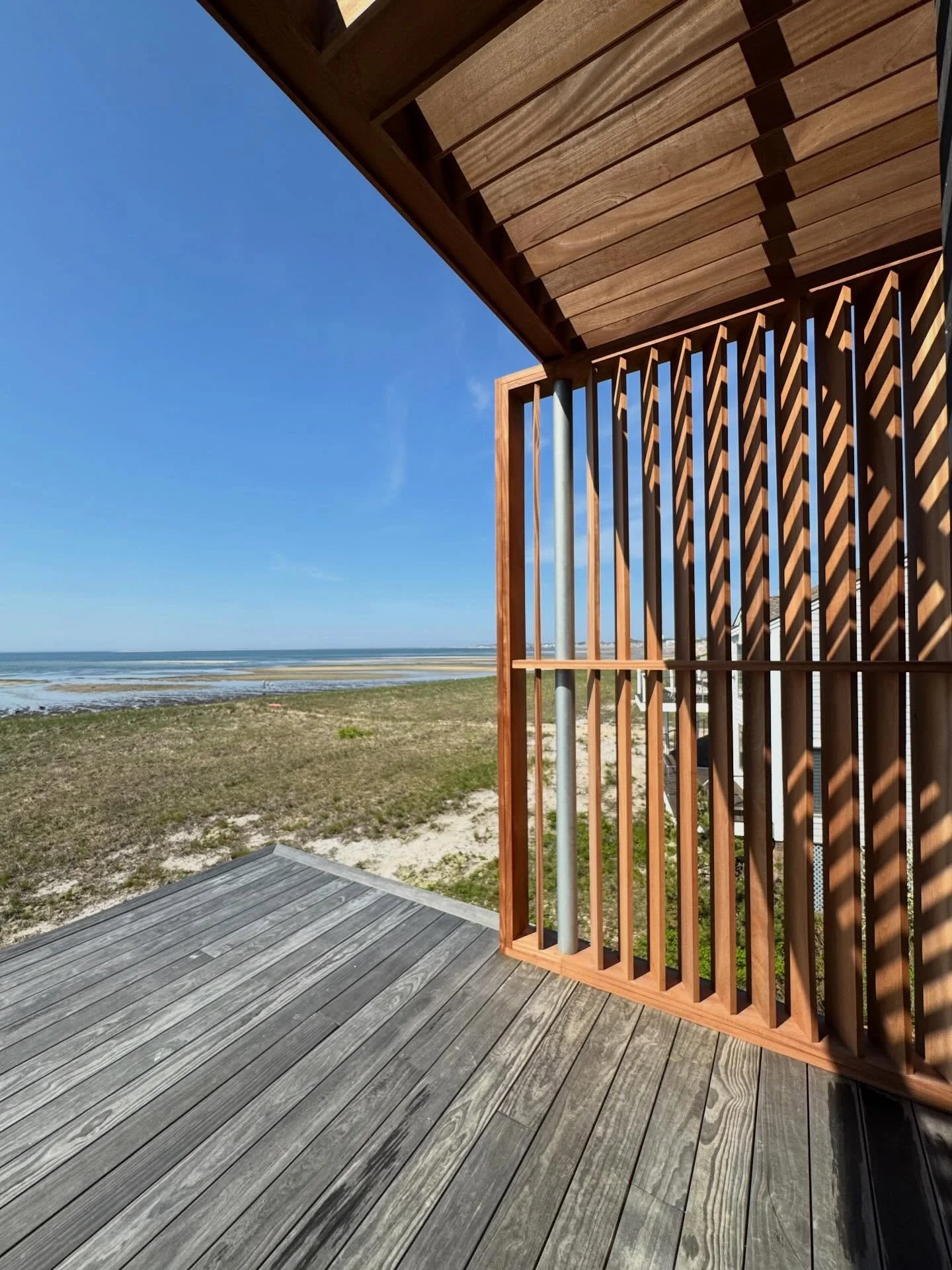 Provincetown exterior views.  Our team working on custom mahogany awning and shade screens.  Awning louvers coordinated with the summer sun. Measuring for the metal handrails coming soon. 
#mahogany shades, #mahogany awning, #capecodbuilders, #custom