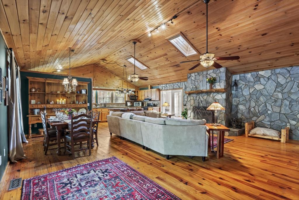 Enjoy the natural light streaming through skylights in this spacious living area, where every detail invites connection, comfort, and calm.