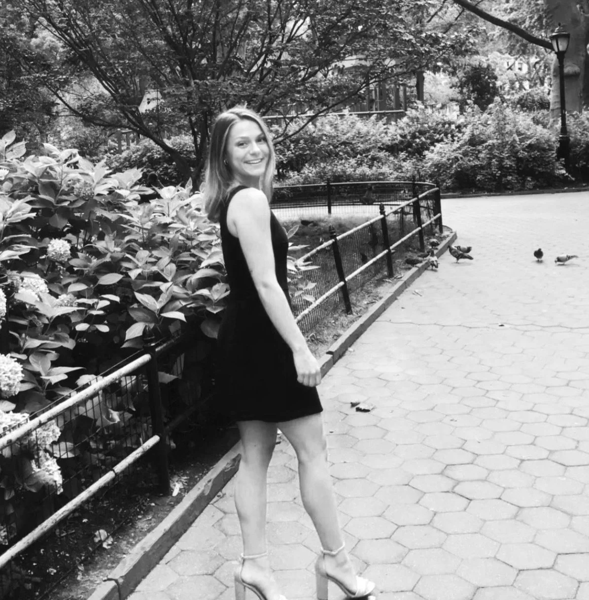 photo of a young woman smiling in Central Park feeling great about her Human Design session with Ahram Arya