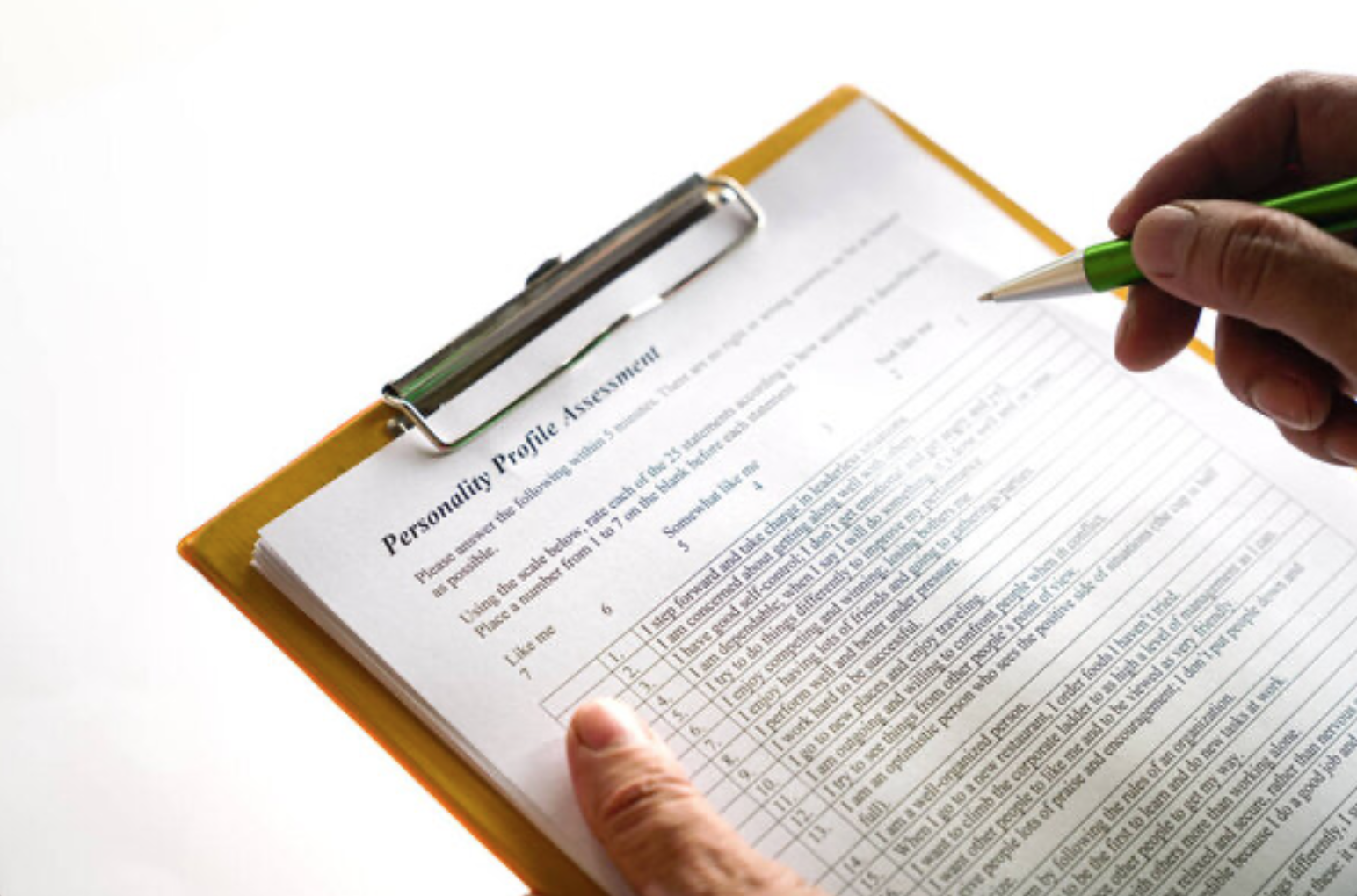 Photograph of a personality test on a clipboard that someone is filling out with the pen, indicating a very outdated way of understanding yourself