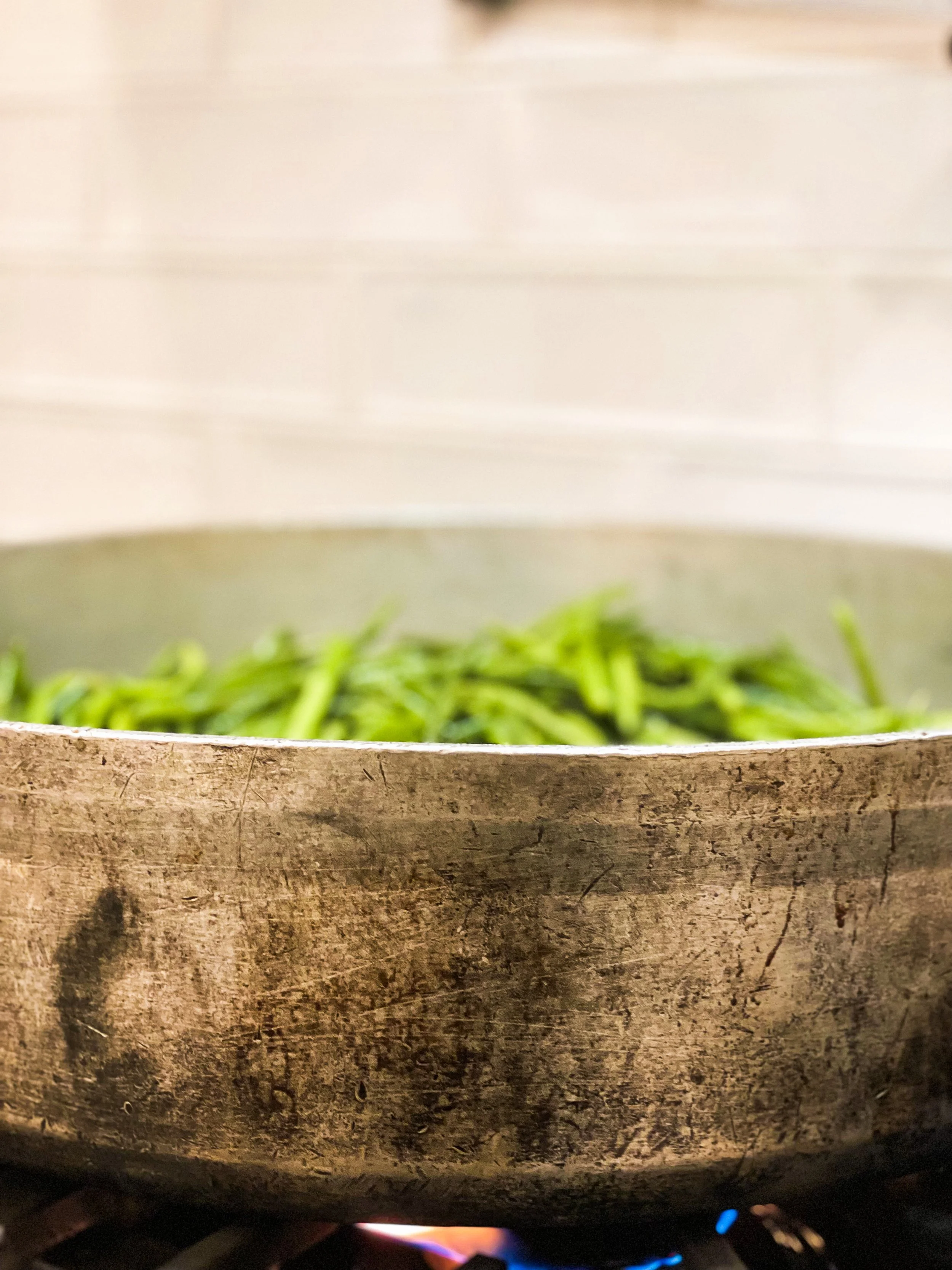 large pot of fresh green beans cooking over a stove