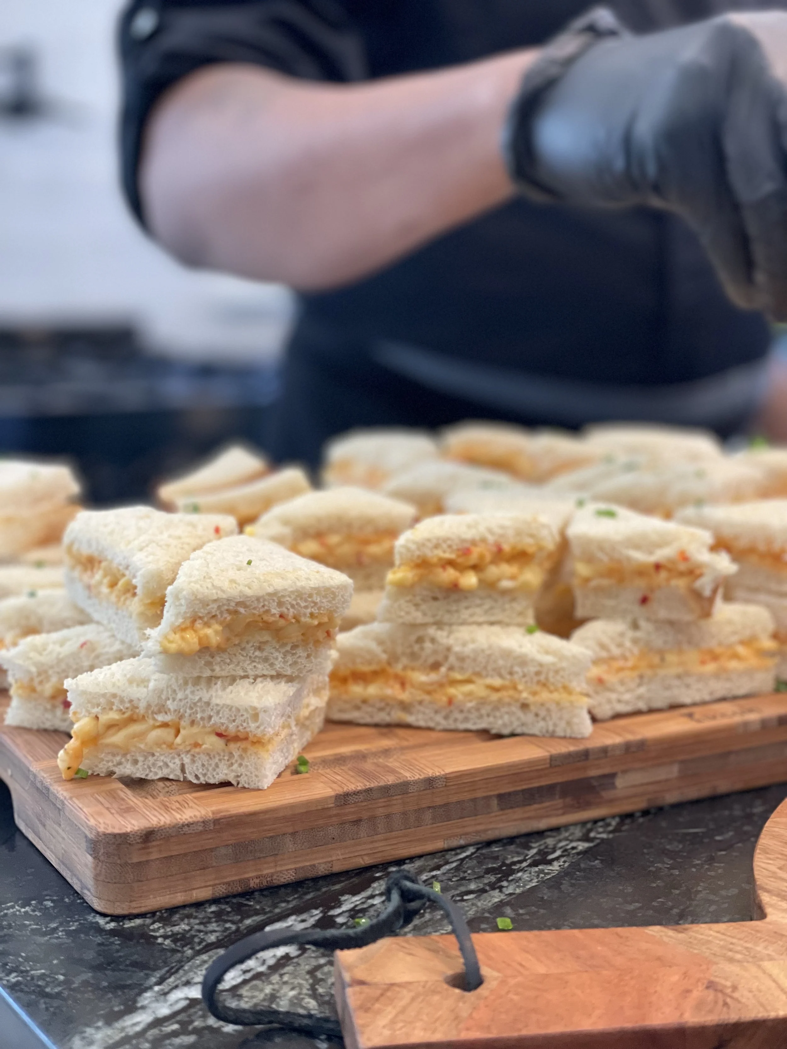 pimento cheese sandwiches on a cutting board
