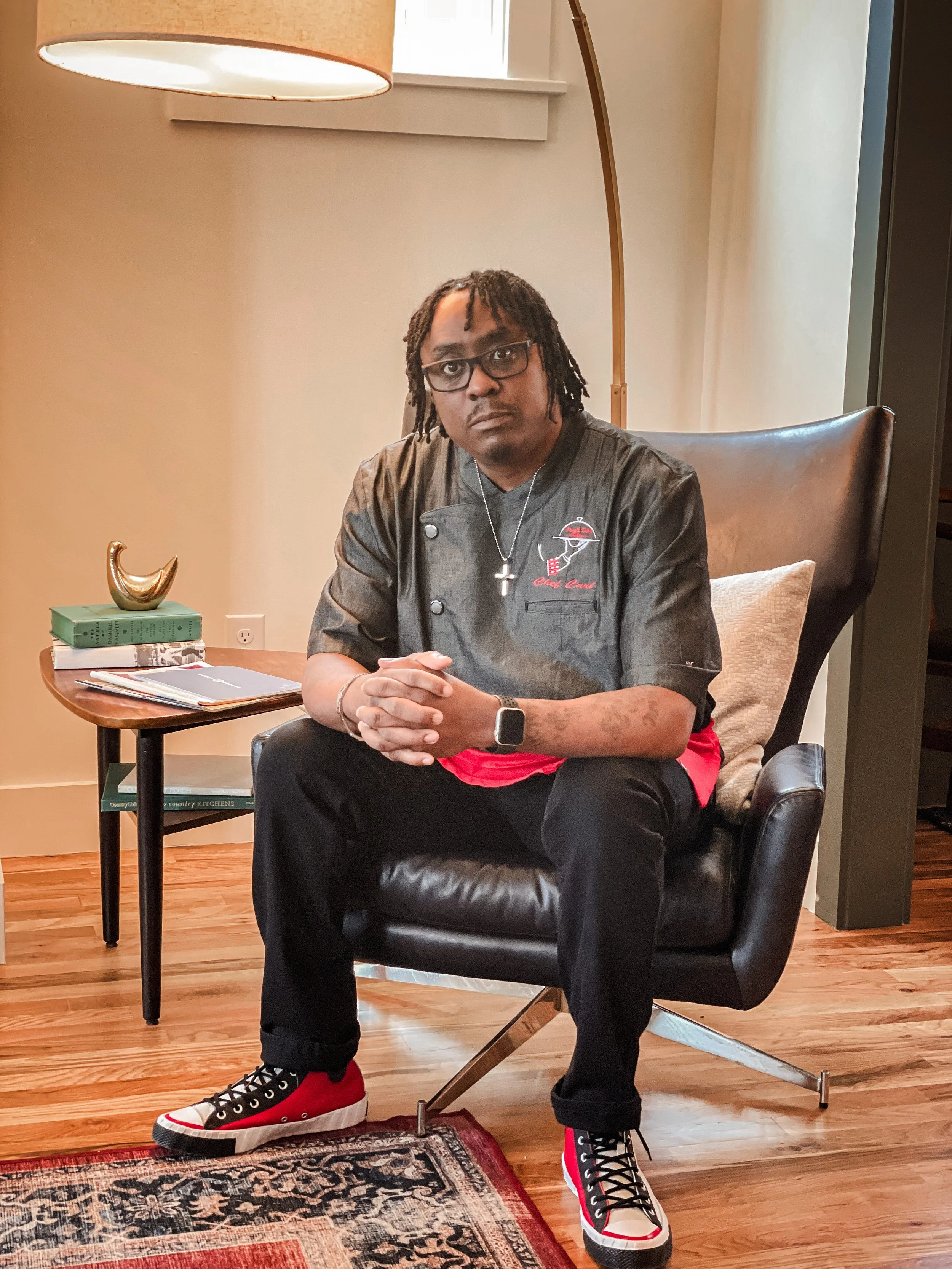 Chef Carl sitting in a chair posing for a picture