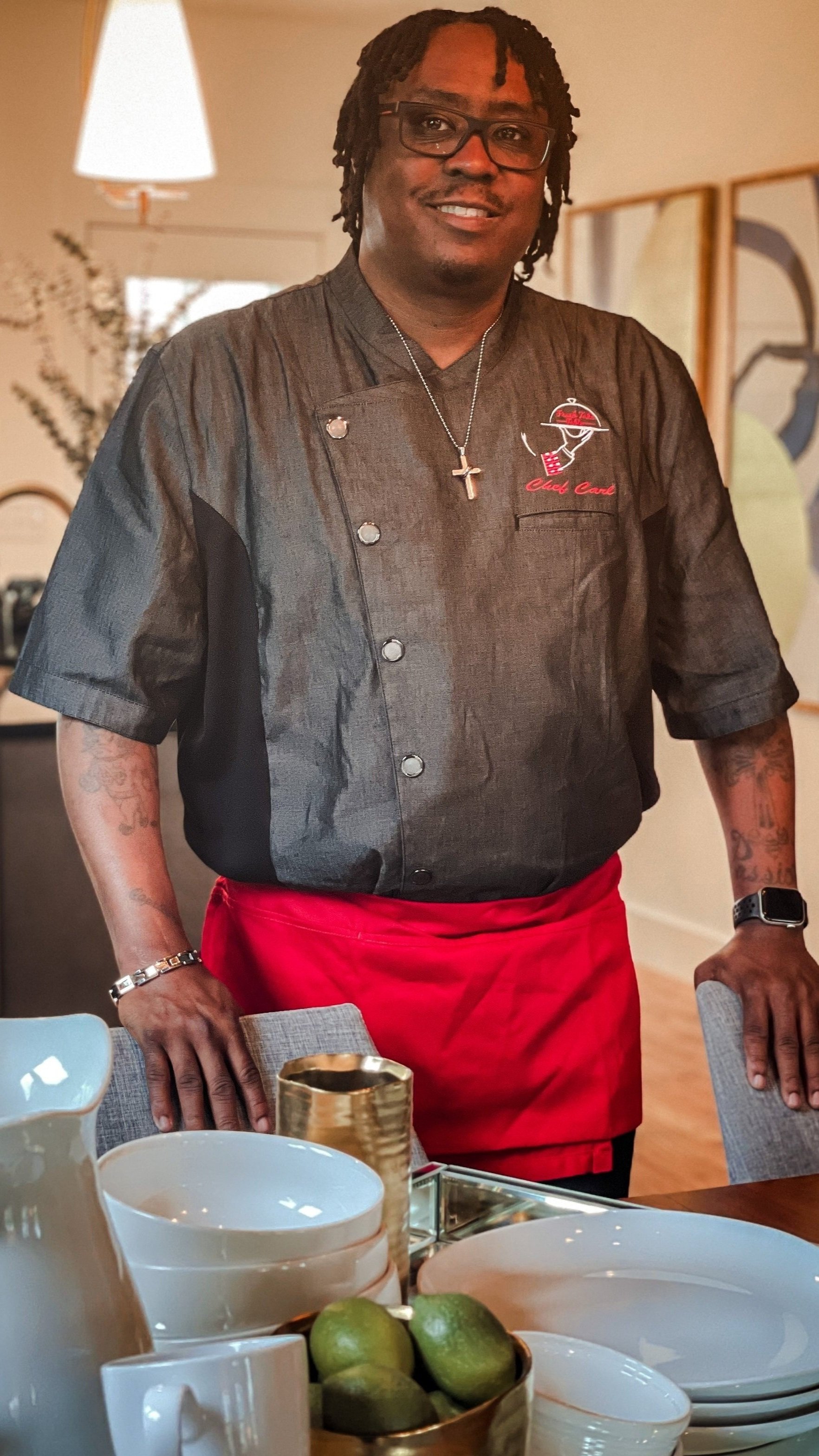 Chef Carl standing at a dinner table for a picture