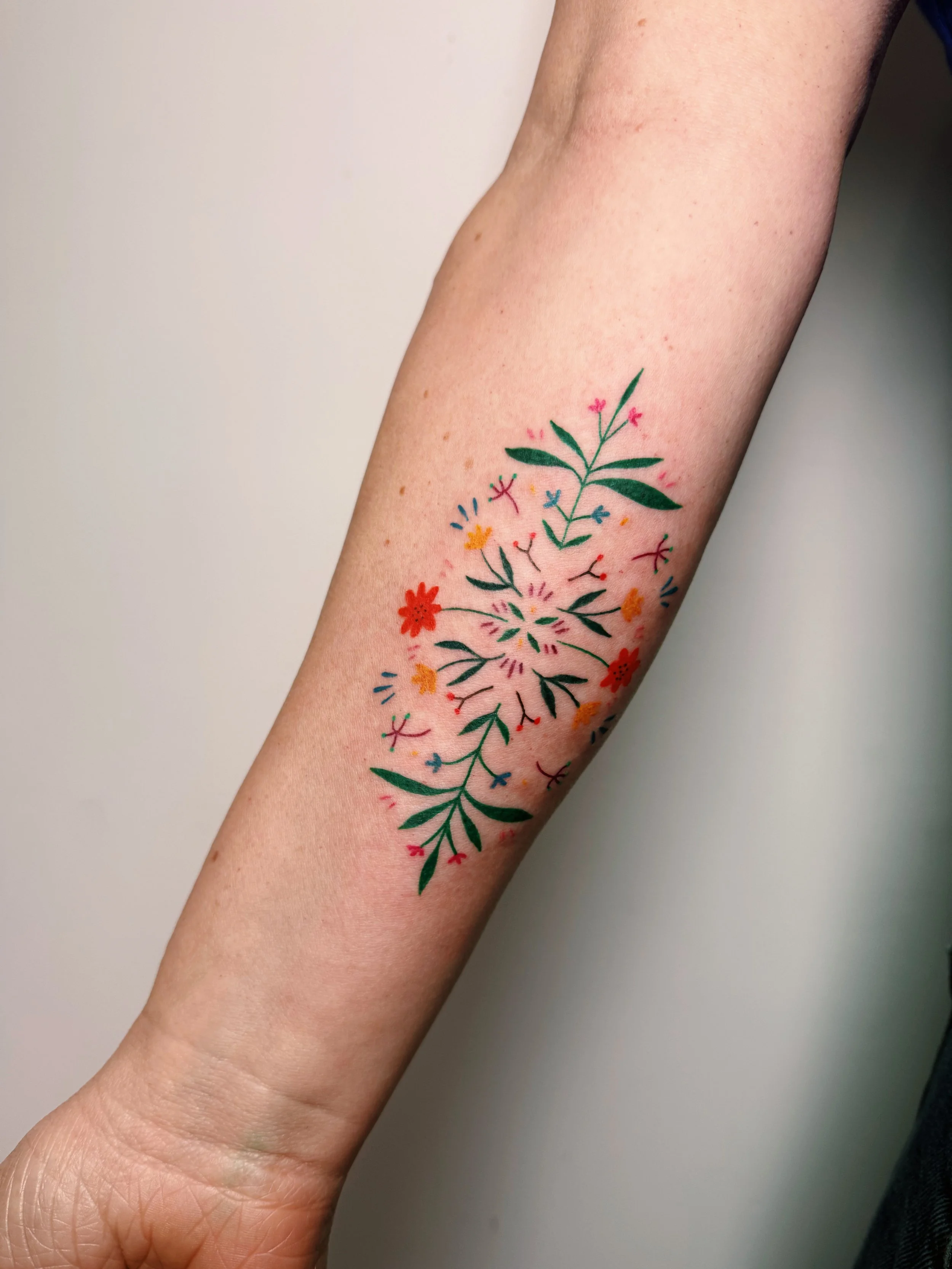 A floral piece tattoo inspired by Ukrainian traditional embroidery