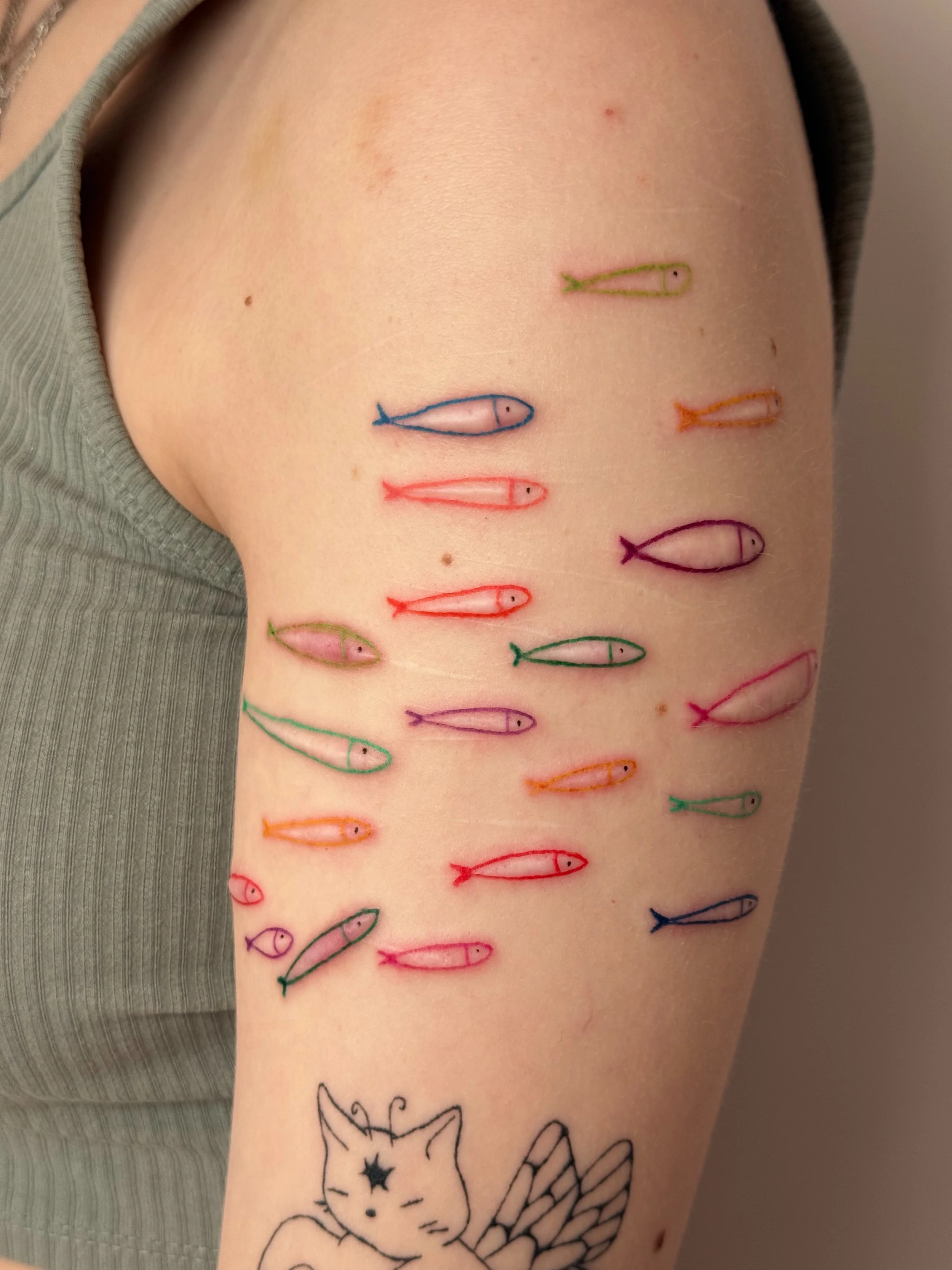 a tattoo of fish drawn around scars