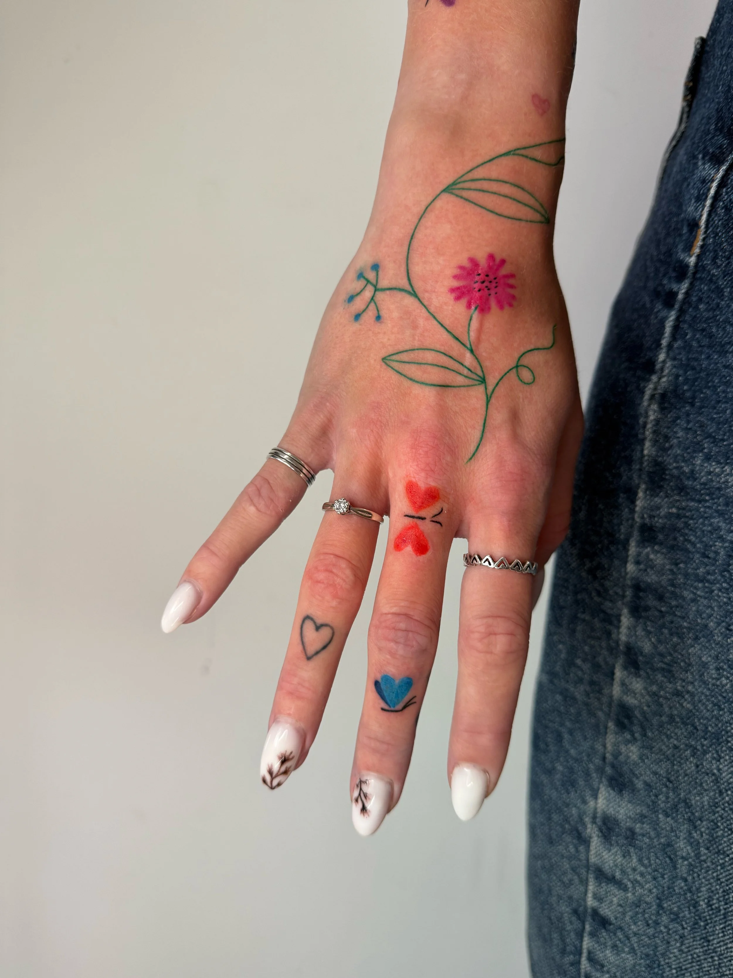 a colorful freehanded tattoo with flowers and berries