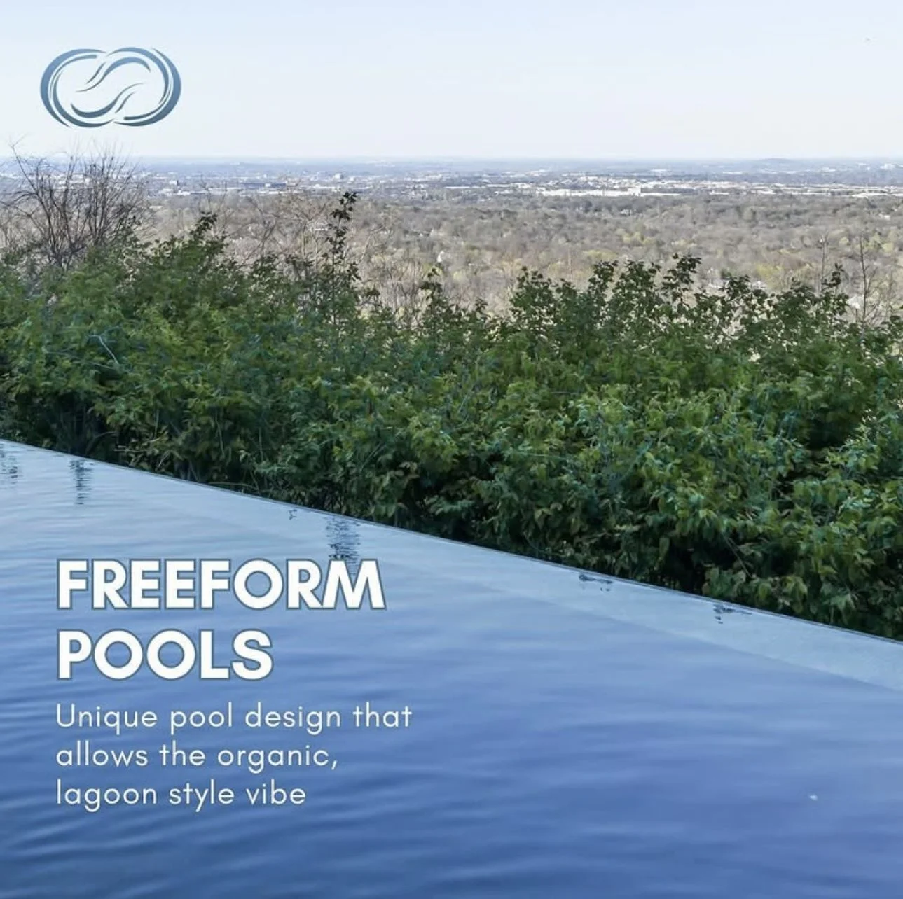 A scenic outdoor view of a lush green hillside, overlooking a distant cityscape with a large freeform in-ground pool in the foreground. The pool has a smooth, organic shape, fitting with a lagoon style design. The sky is clear and bright, with minimal clouds.