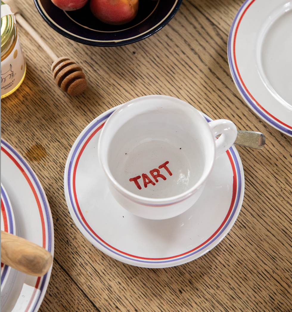 Hand-painted red and blue striped ceramic teacup and saucer from Tart's Under the Sun collection, handcrafted in Mallorca