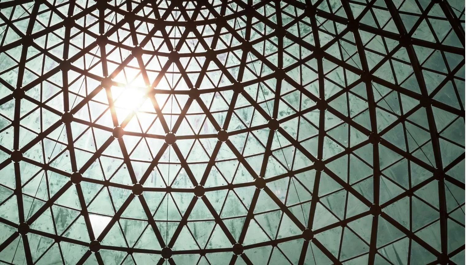 Sunlight through a geodesic glass dome built from small triangular panes