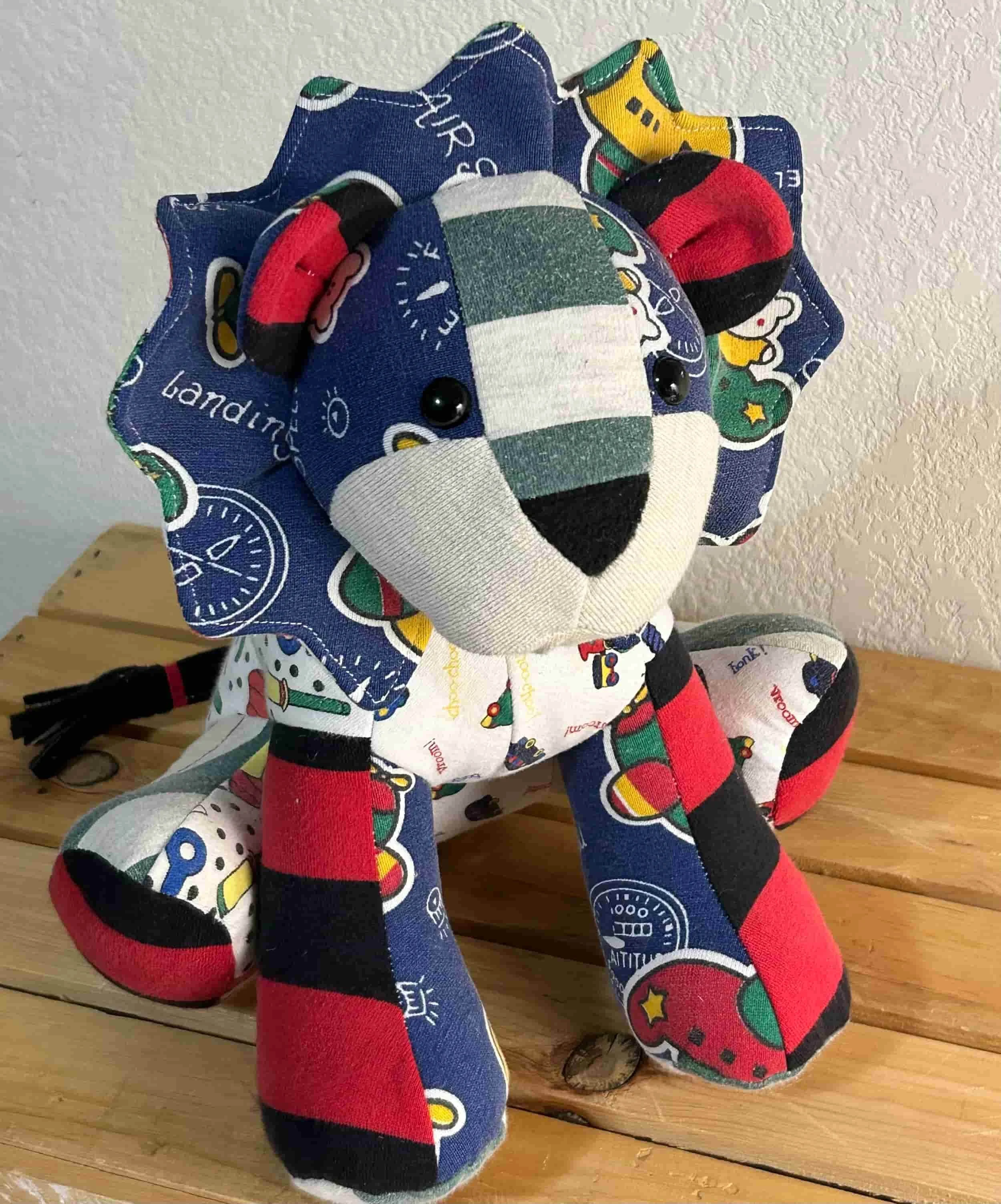Memory lion made from your clothing – a unique stuffed lion keepsake with vibrant colors and patterns.