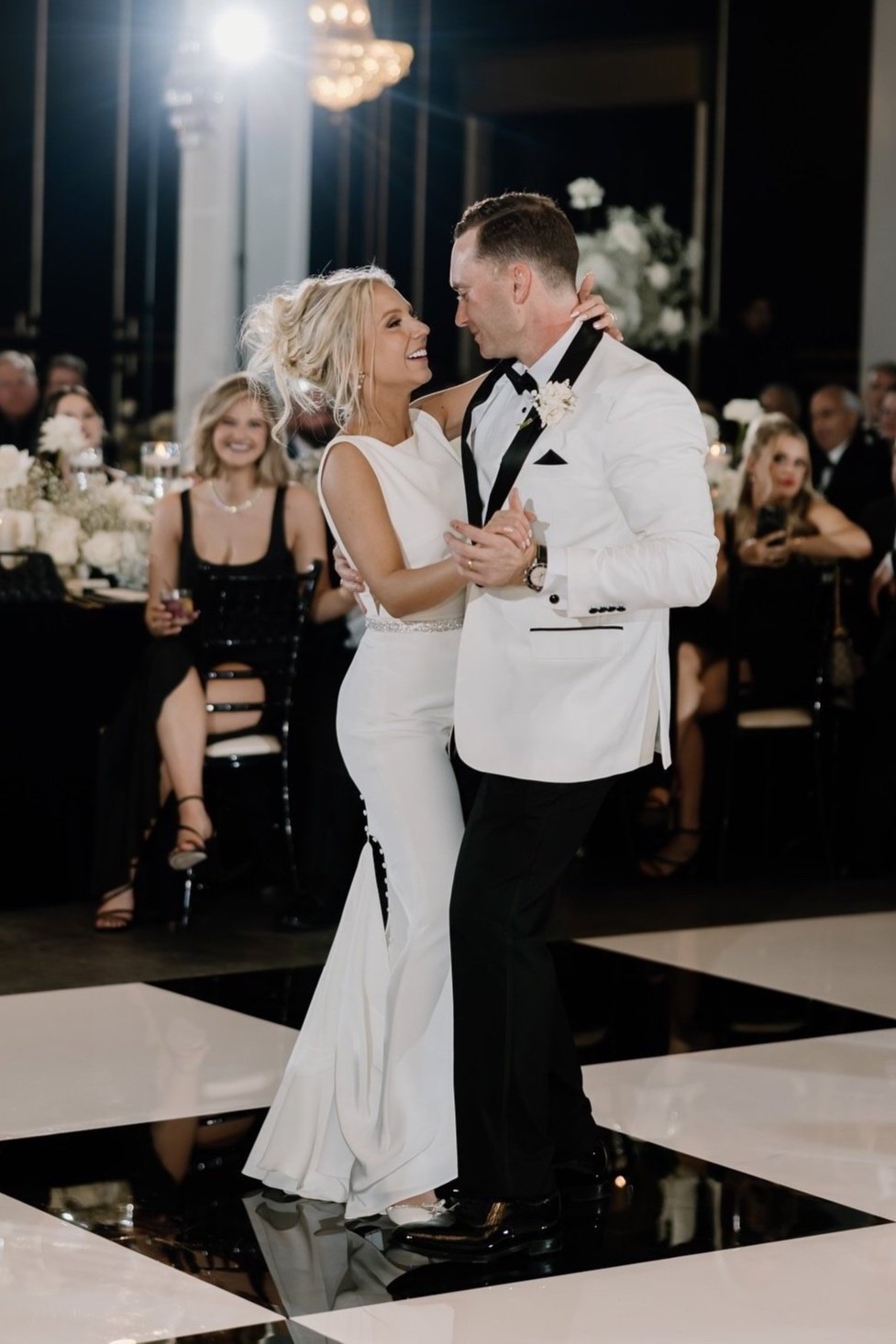 Groom wearing white tuxedo