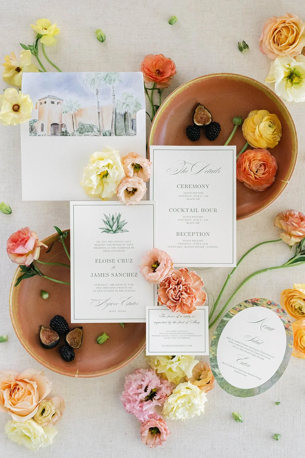Invitation cards and flowers laid on a table with terracotta bowls at Agave Estates in Houston TX
