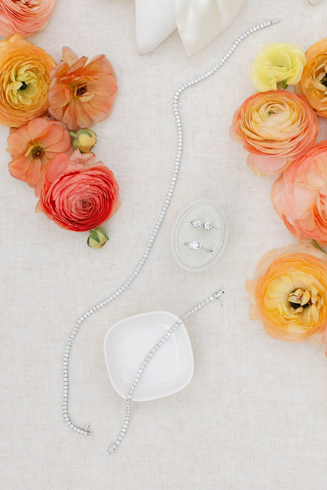 Diamond jewelry and flowers on a white table at Agave Estates in Houston TX