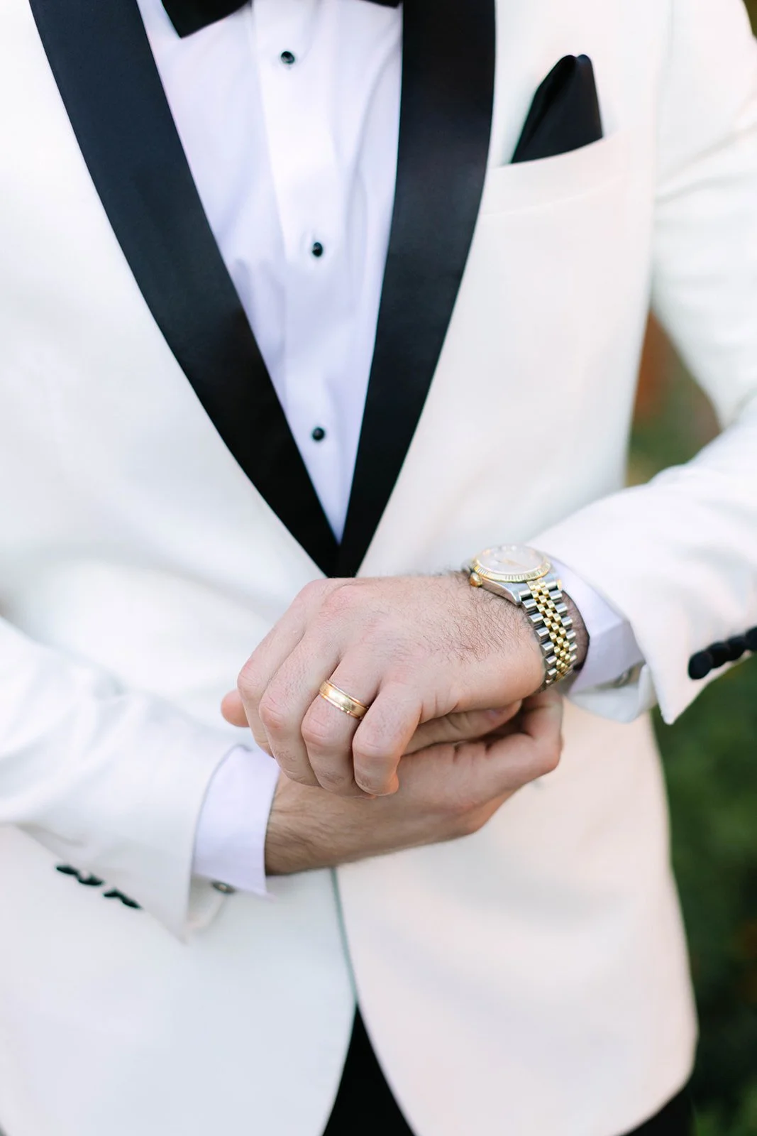 Close up of model wearing white tuxedo.