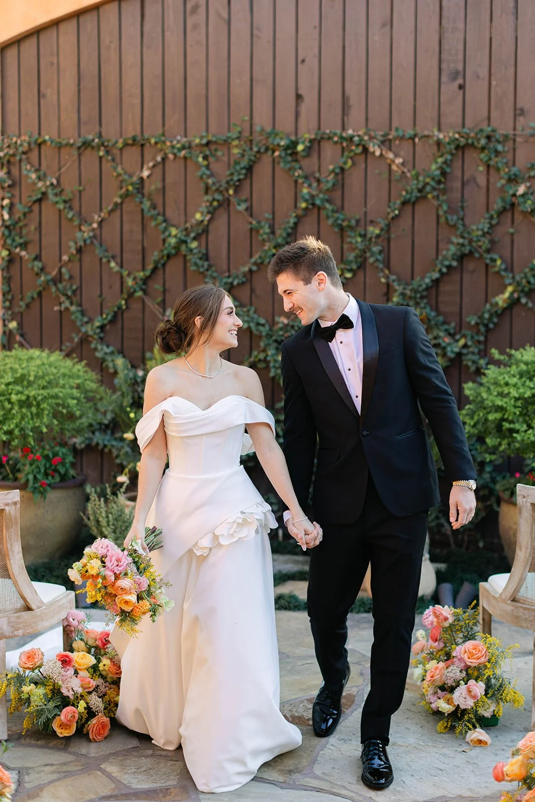 Bride and groom holding hands at Agave Estates in Houston TX