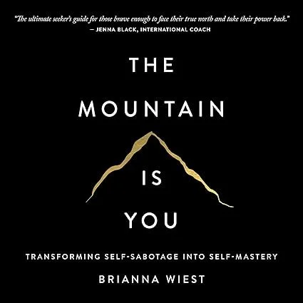 Black cover featuring a gold outline of a mountain. The text reads: 'The mountain is you,' with a quote at the top from Jenna Black and a subtitle at the bottom from Brianna Wiest about transforming self-sabotage into self-mastery.