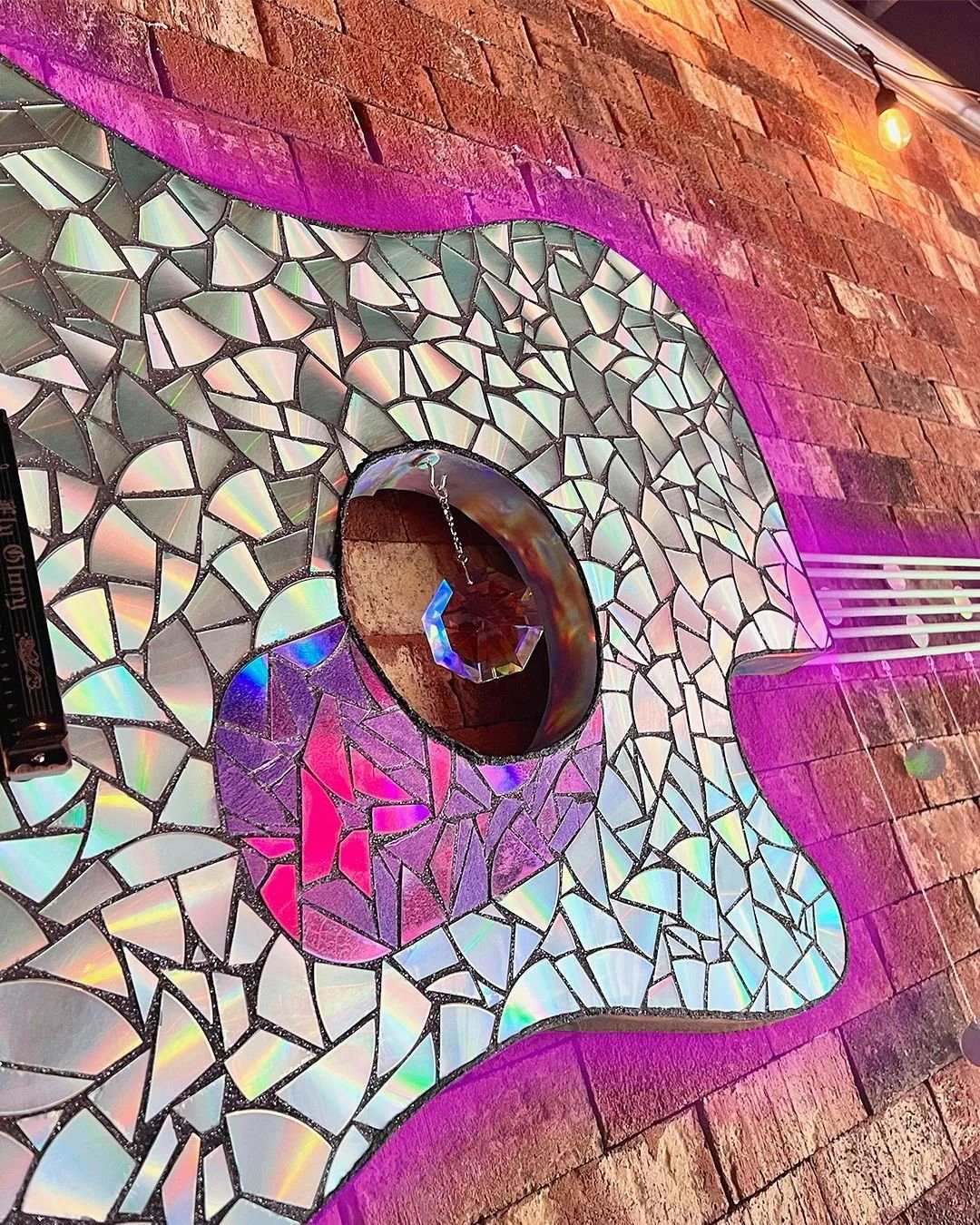 'Joyous Symphony' - [ d e t a i l ]

This art installation used 50+ recycled CDs, a harmonica, and vintage vinyl records to build the intricate details of the 16' guitar. It was hung in a music venue that offers live shows, local open mics, and other
