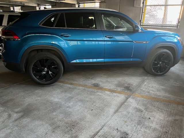 A blue SUV parked in an indoor parking garage.