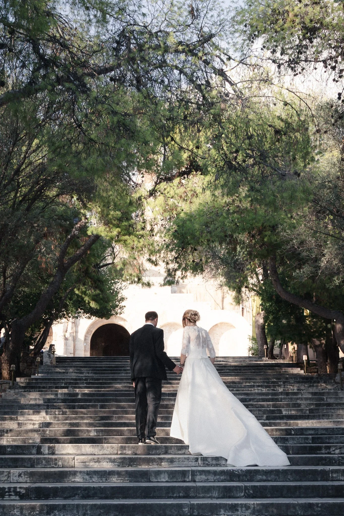Wedding couple climbing steps, Herodion Athens - Alexandros Aidonis