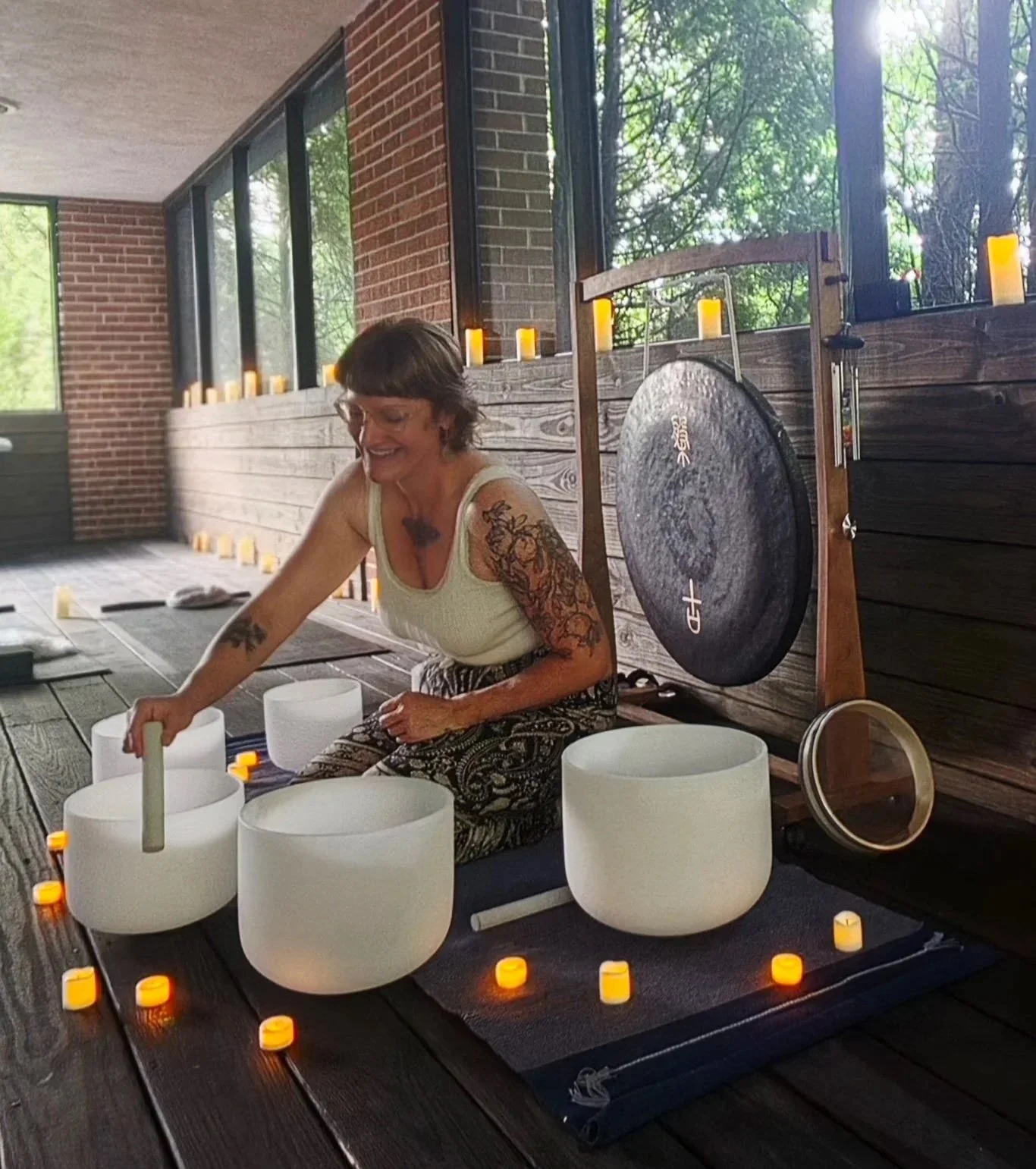 Dōm founder Maggie Rice playing crystal singing bowls during a sound bath in Highlands, NC