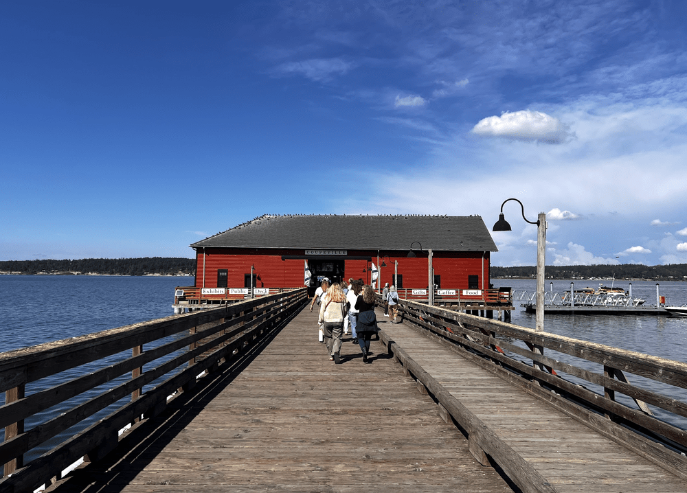 The Coupeville wharf and its red building on Penn Cove