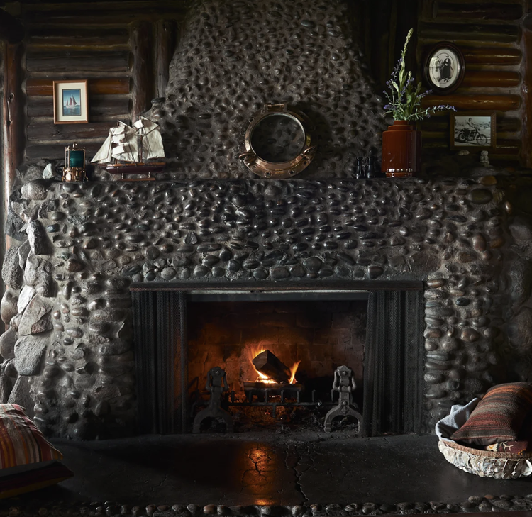 The river-rock fireplace in the main lodge