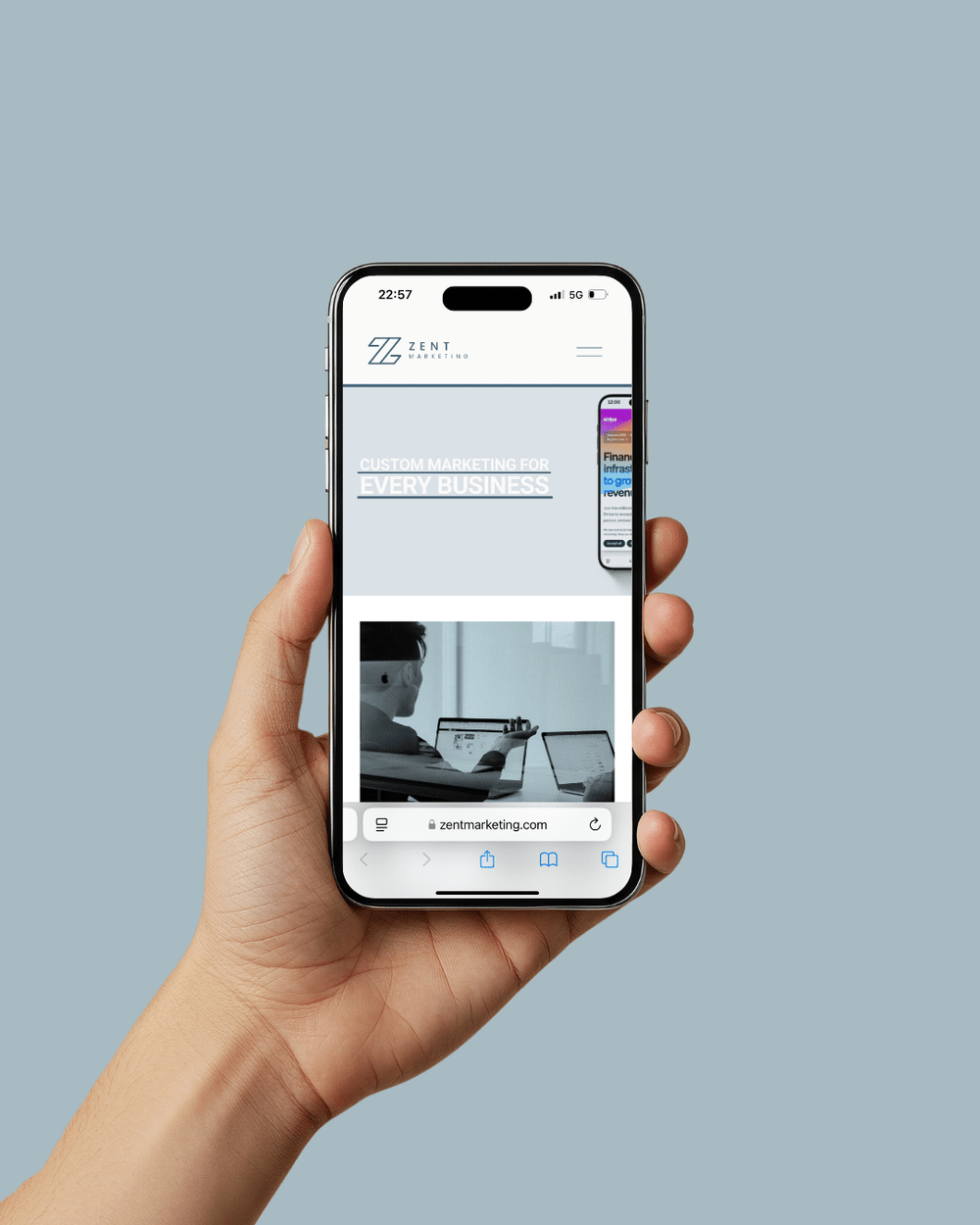 Man holding phone showcasing the Zent Marketing website