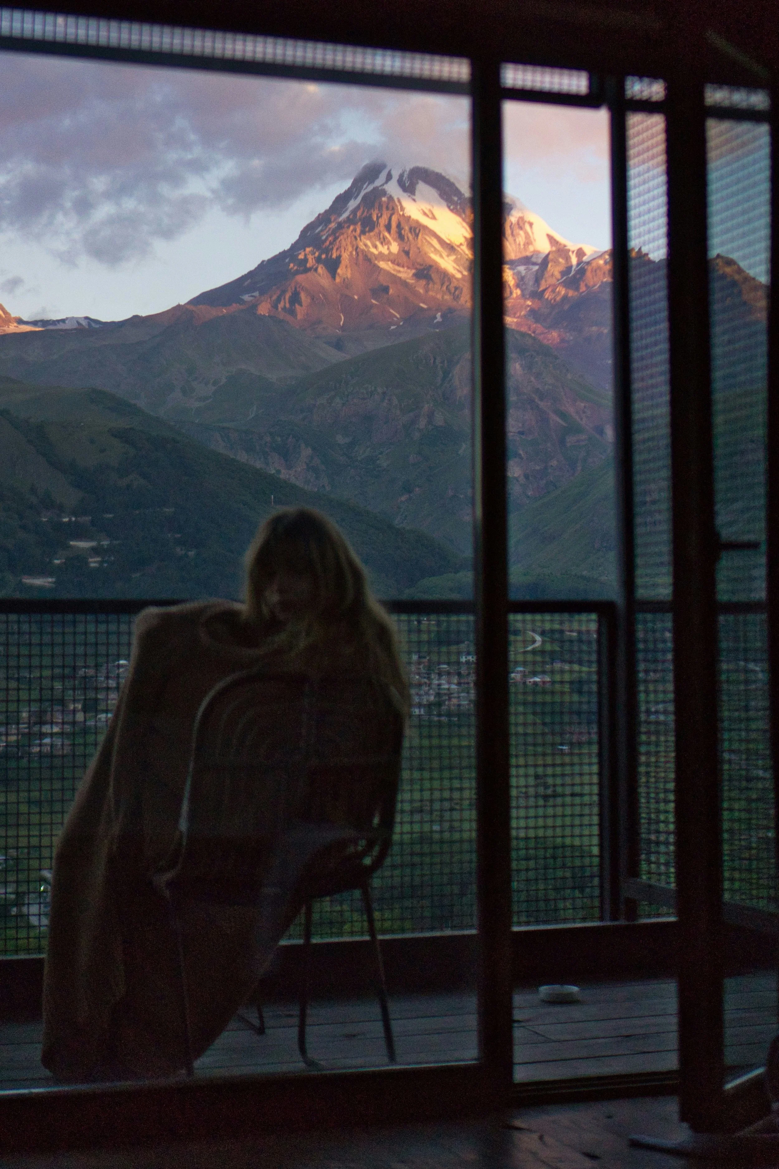 Woman looks out onto mountain