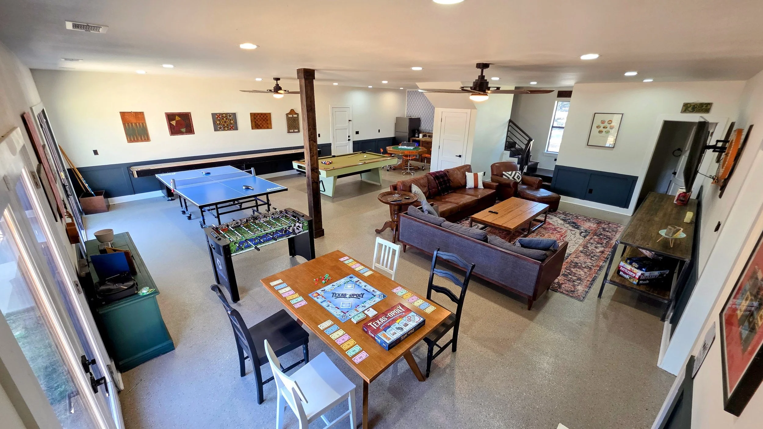 Pro-level entertainment game room inside the main house at Larue Landing, featuring a billiard table, ping pong, shuffleboard, and poker table.
