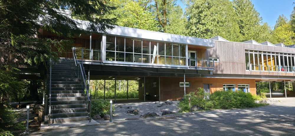 The main Cheakamus Centre building framed by forest