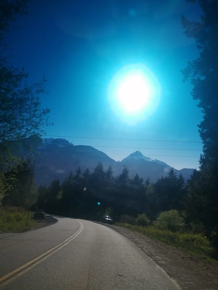 The road into the retreat beneath the sun and mountains