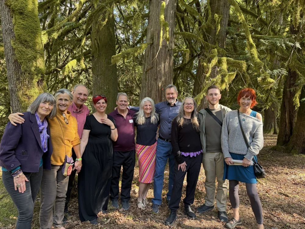 The inaugural retreat team standing together in the forest