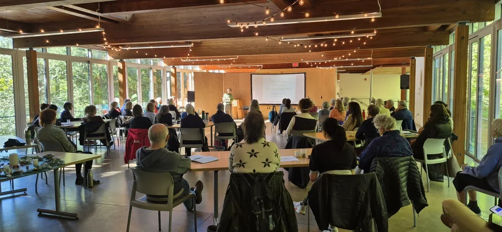 A retreat session in a bright, wood-lined conference room