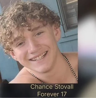 Portrait of Chance Stovall with curly hair, smiling, with a necklace, against a blue background, with the text 'Chance Stovall Forever 17' at the bottom.