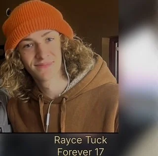 Young person with curly hair wearing an orange beanie and brown hoodie, listening to headphones, with text 'Rayce Tuck Forever 17'.