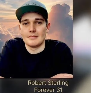 A young man wearing a baseball cap and black shirt taking a selfie outdoors during sunset with clouds in the sky, and text overlay reading "Robert Sterling Forever 31."