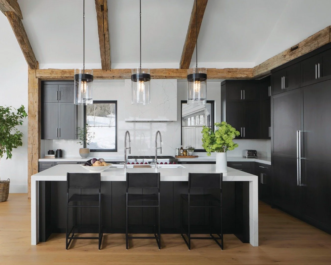 Design Feature: When the mountains call, design answers. 🏔️✨ This Red Sky Ranch retreat blends reclaimed beams, sleek monochromatic walls, and floor-to-ceiling glass to create a home that feels both modern and timeless. From a custom wine display to
