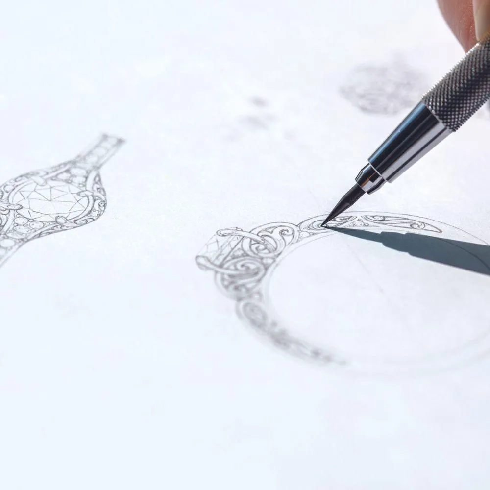 Close-up of an intricate jewelry design sketch on white paper with a mechanical pencil.