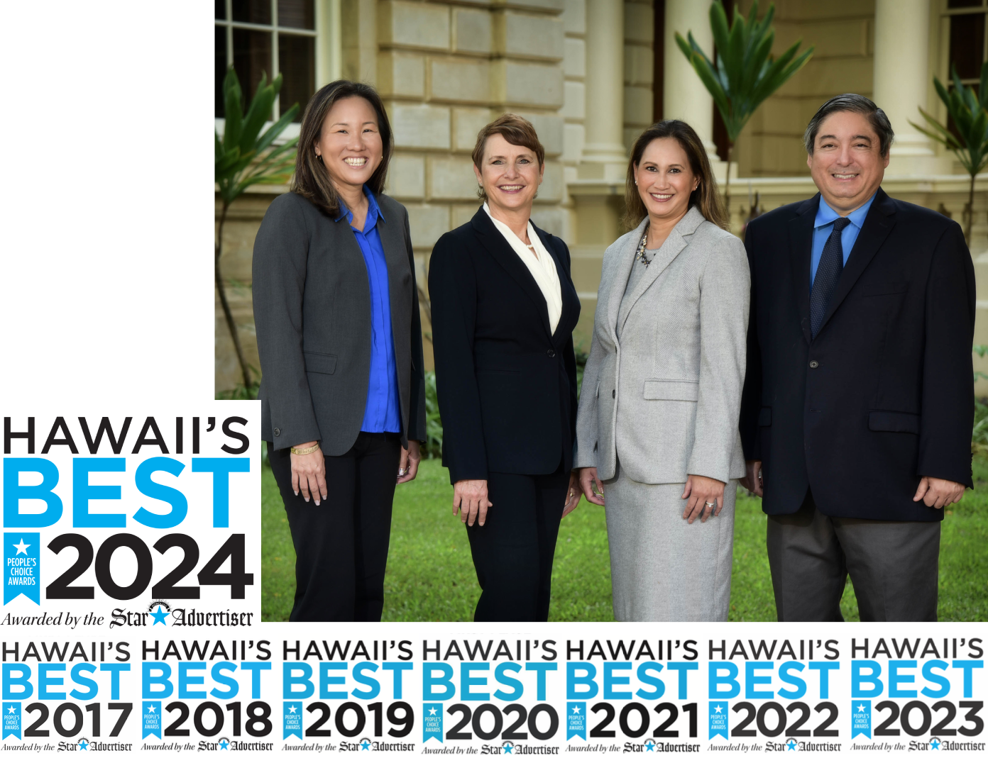 Four professionally dressed individuals standing outside in front of a building with large plants and columns, smiling for the camera