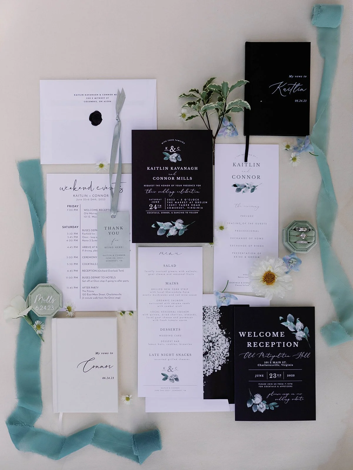 Wedding invitation suite including an envelope, RSVP card, menu, schedule, thank you card, and other stationery, decorated with flowers, ribbons, and rings.