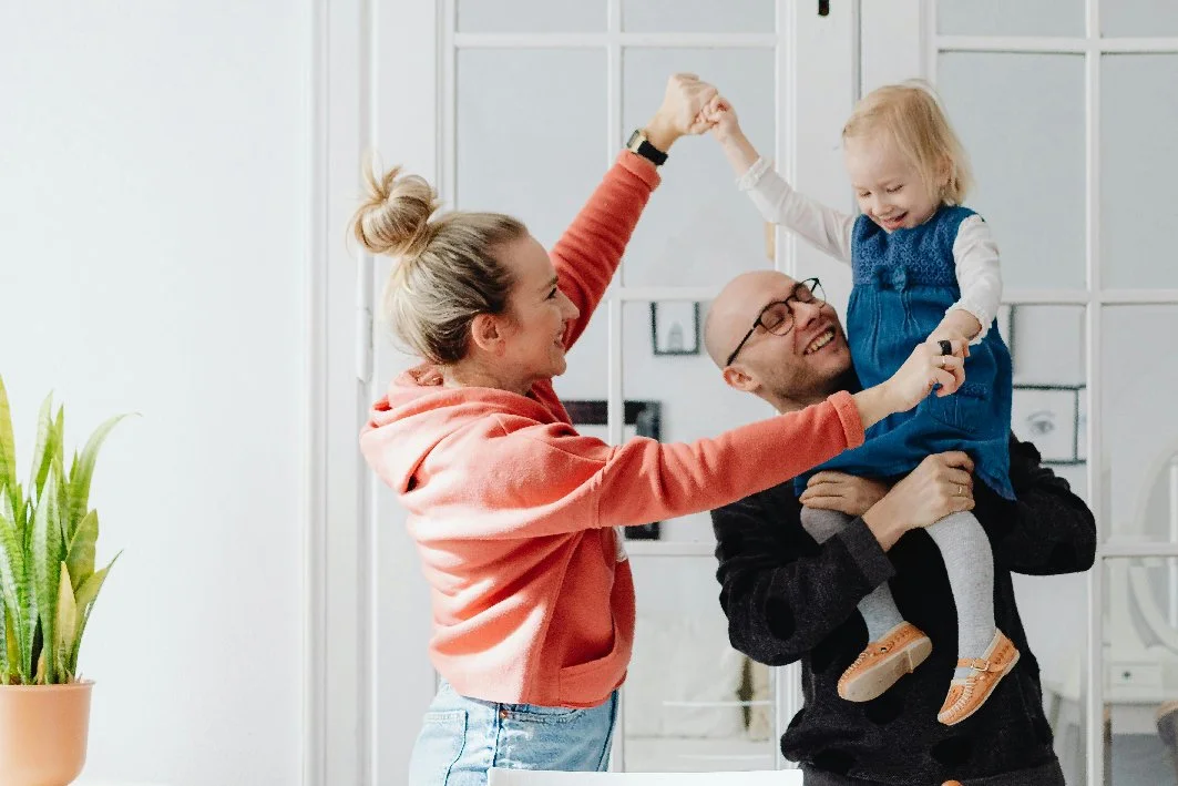 mother and father holding their child up