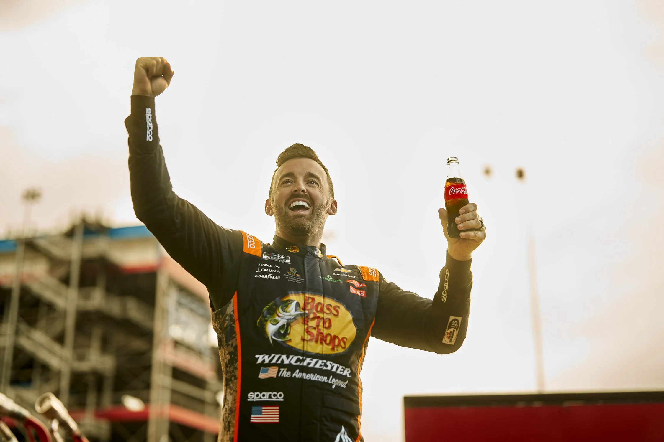 Nascar with Coca-Cola and Hales photo video commercial advertising campaign austin dillon cheering and holding coca cola bottle infront of track